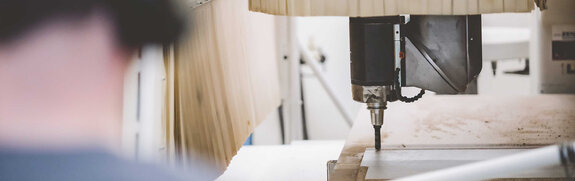 Zenit Messebau employee working with wood on our CNC router Zenit Messebau employee working with wood on our CNC router